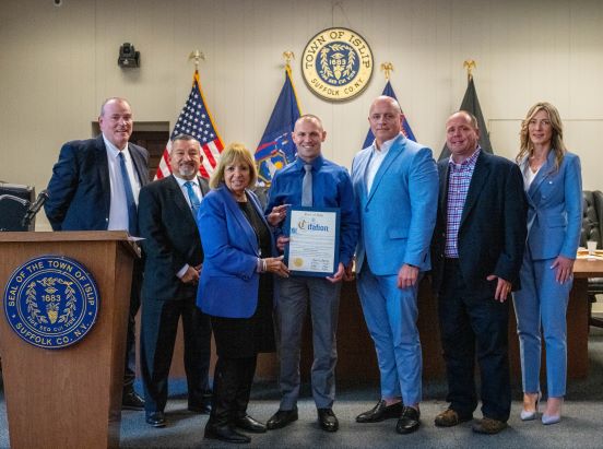 Town Board, Supervisor, and local hero pose for group photo