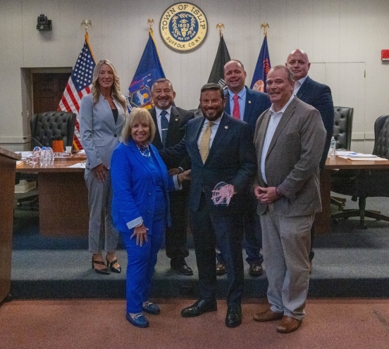 Town board in group photo with honoree
