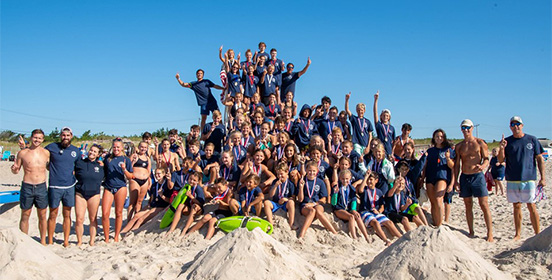 A group photo of all the Jr. Lifegaurds and coaches on top of the lifegaurd tower