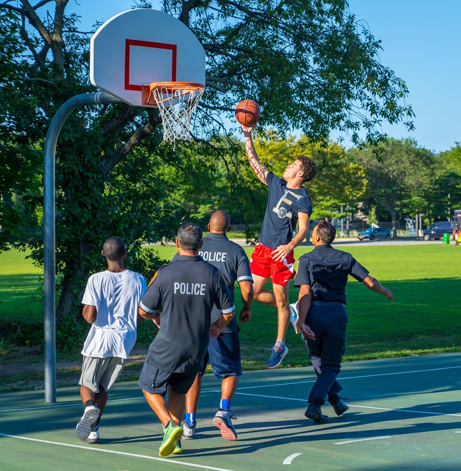 police officers from Suffolk's Third Precinct play basketball with members of the community and Islip Town Park Rangers