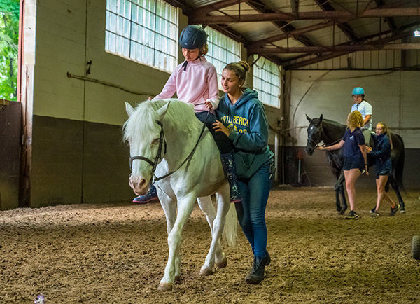 Child rides a horse at the Town of Islip Equestrian Camp