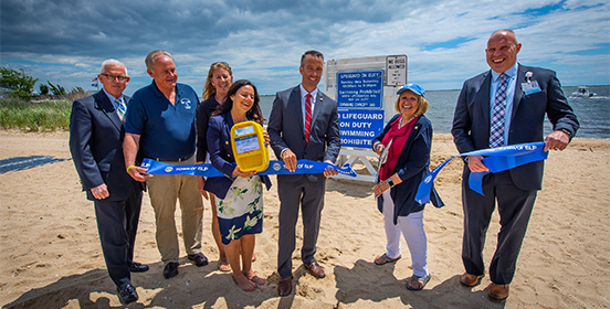 Supervisor Carpenter stands with Babylon and Islip town officials at the free Sunscreen dispensaries unveiling 