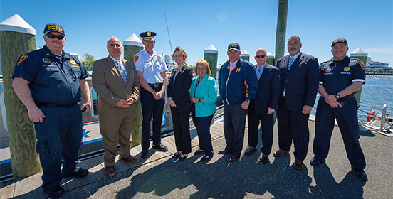 Supervisor Carpenter stands with Councilman John C. Cochrane, Public Safety and DPW Commissioners and members of the Suffolk County Police Department