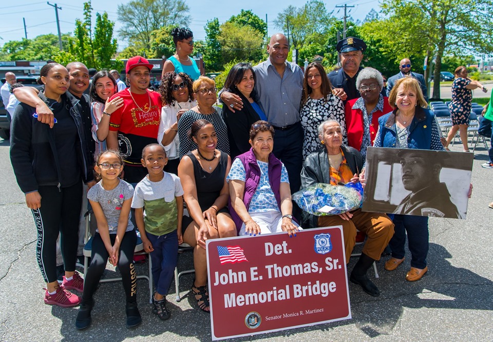 Supervisor Carpenter stands with the family of Det. Thomas who recently had the bridge crossing Southern State Parkway on 5th avenue named after him.