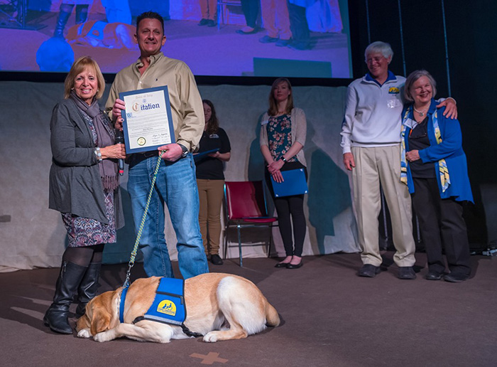 Supervisor Carpenter presents Paul Monfre a citation of honor as he receives his service dog Valor VII