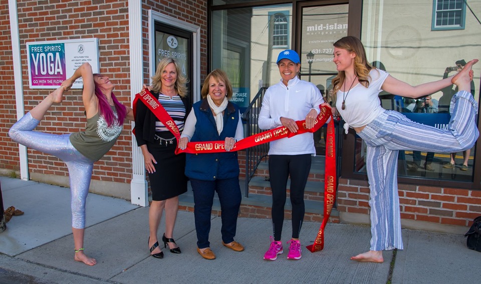 Supervisor Carpenter and Councilwoman Mary Kate Mullen pose with the Sayville Chamber of Commerce and the owners of Free Spirit Yoga outside the new business