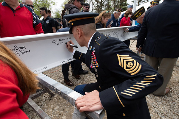 Military officer signs the beam for the new museum