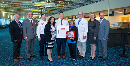 Officials stand together with the New Bleed Stations (L to R) Kevin Burke, Airport Security Director, Long Island MacArthur Airport; Gerry Destefano, Northwell Health; Al Cinotti, Chief of Airport Fire Rescue; Donna Moravick, Executive Director, Southside Hospital; Timothy Dackow, Northwell Health; Angie Carpenter, Islip Supervisor; Dr. Daniel Galvin, Northwell Health; Shelley LaRose-Arken, Airport Commissioner; Anthony Pellicone, Northwell Health. 