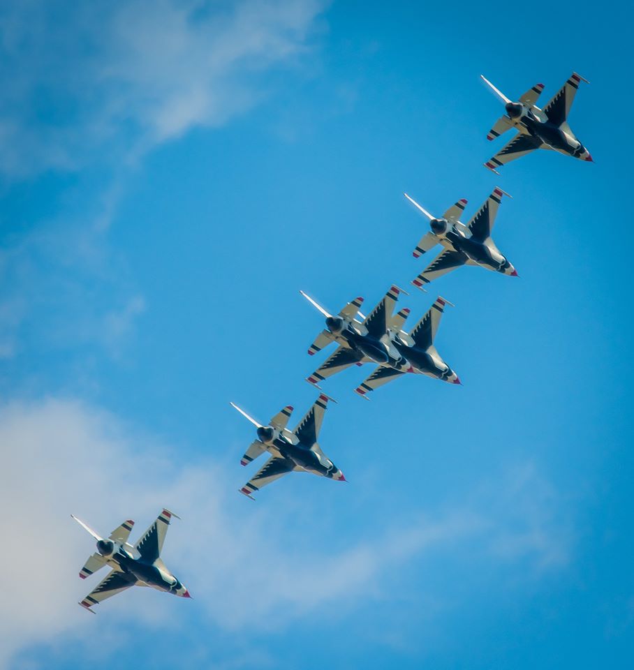 6 jets in formation fly across brilliant blue sky