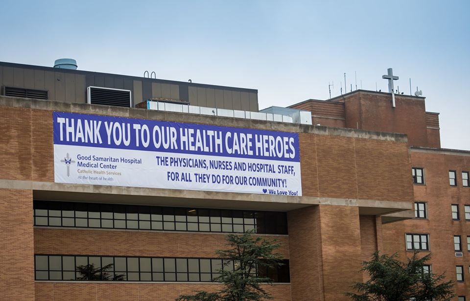 large banner on top of Good Sam Hospital thanks the medical staff