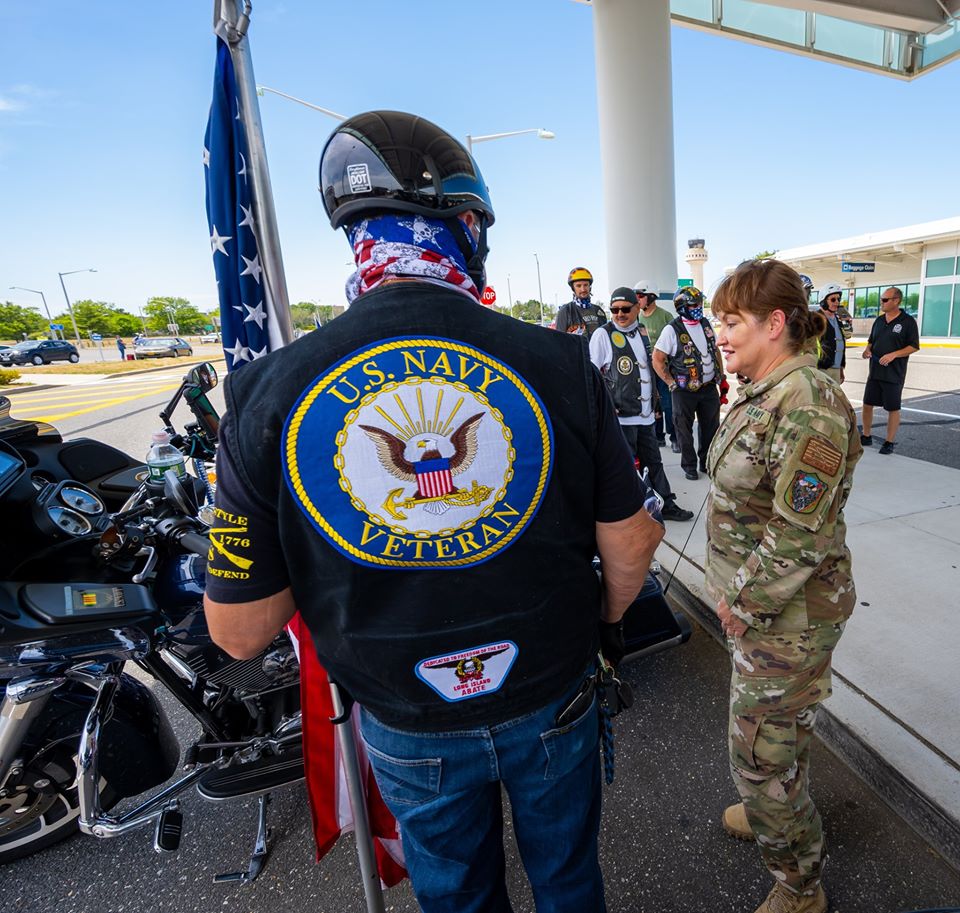 US Navy Vet with motorcycle greets Commander