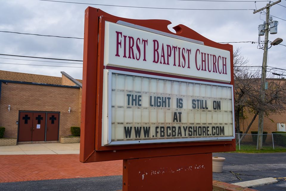 church sign with fence