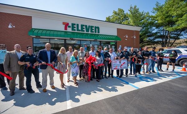 supervisor and town board stand with community leaders in front of the new 7-eleven in sayville