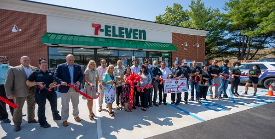 supervisor and town board stand with community leaders in front of the new 7-eleven in sayville