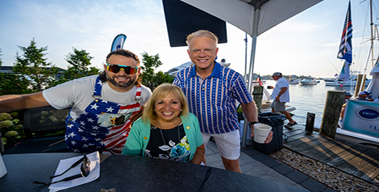 supervisor carpenter stands with boomer esiason and gio of the morning show Boomer and gio at the Lake House in Bayshore
