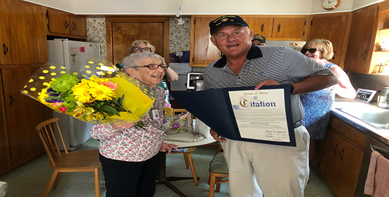 Councilman John C. Cochrane Jr. holds up a citation for Estelle, a 102 year old veteran of the US Army. 