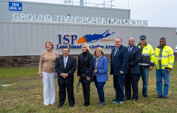 Town Officials stand in front of the new Ground Transportation Facility