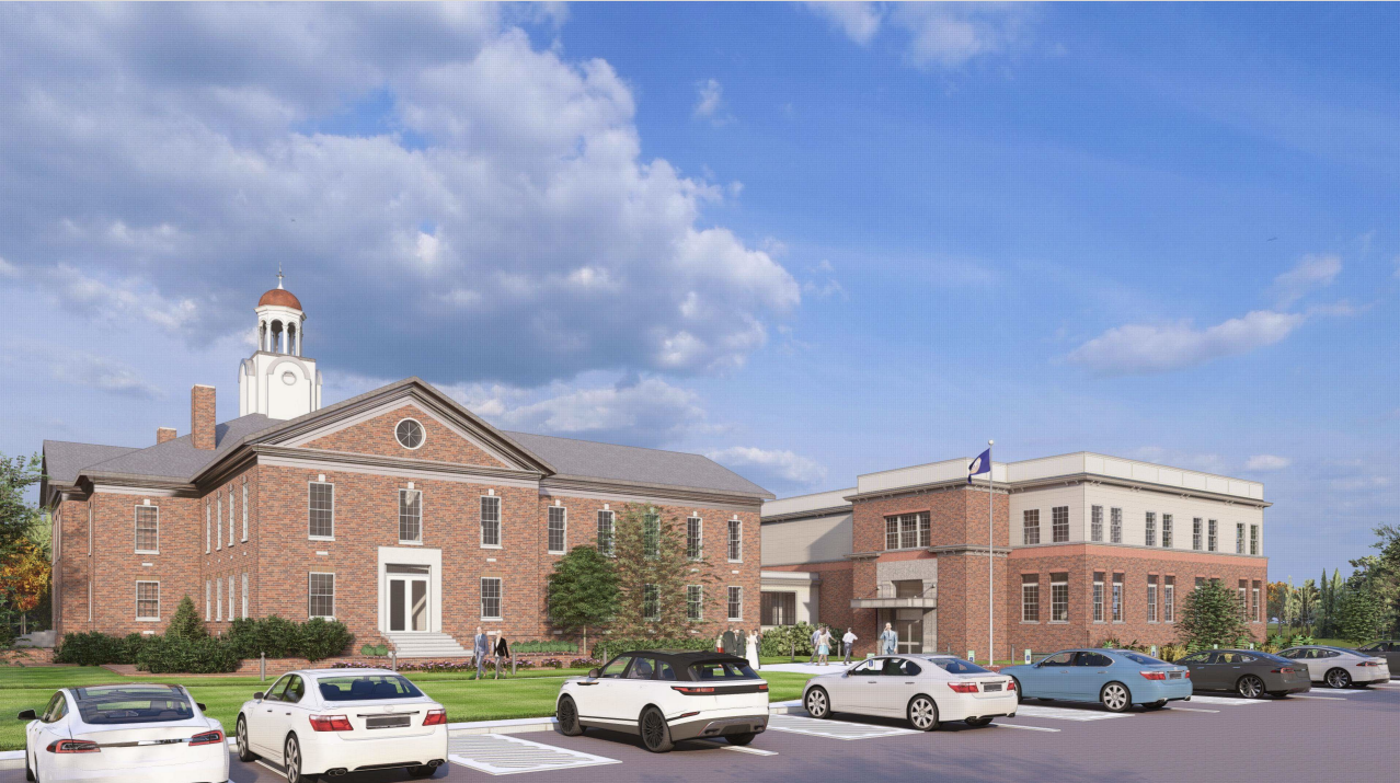 Town Hall Annex building, photographed from a slightly angled perspective with parked cars in the foreground.