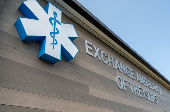 close photo of the Exchange Ambulance logo on facade of building