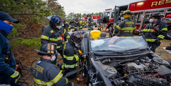 first responders in gear pratice on vehicle