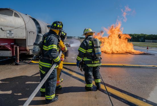 Fire Rescue Members in gear fight fire