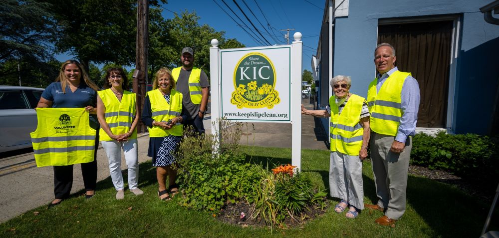 Keep Islip Clean members and Supervisor Carpenter in group shot wearing KIC vests