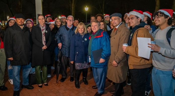 wide group shot of local officials and tree lighting goers