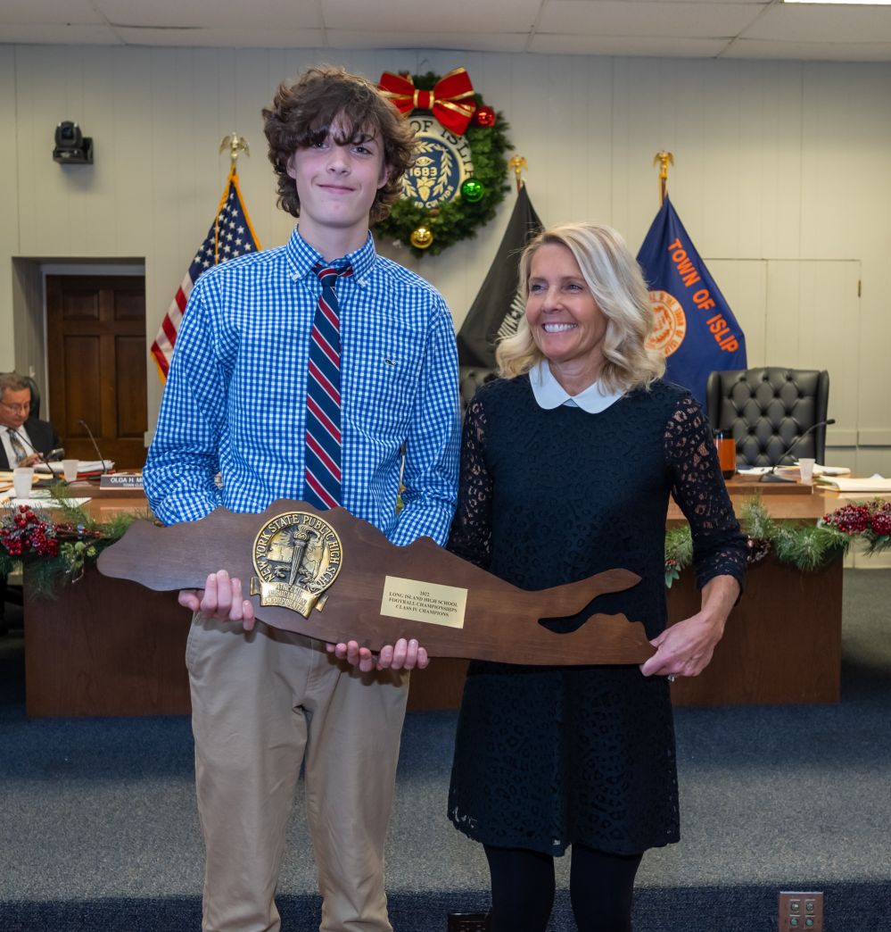 Outgoing Councilwoman Mary Kate Mullen photo with her son, a member of the championship team