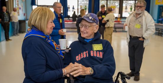 Supervisor Carpenter greets a disabled veteran senior, who smiles upon her.