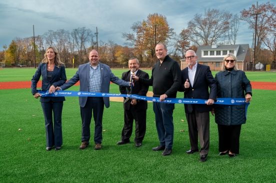 Town Officials holding Town Ribbon to be cut