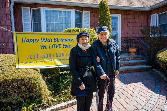 Anthony and Wife of 71 years hold hands outside home