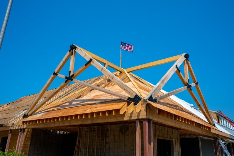 craft framing of main entrance roof with American flag proudly at top