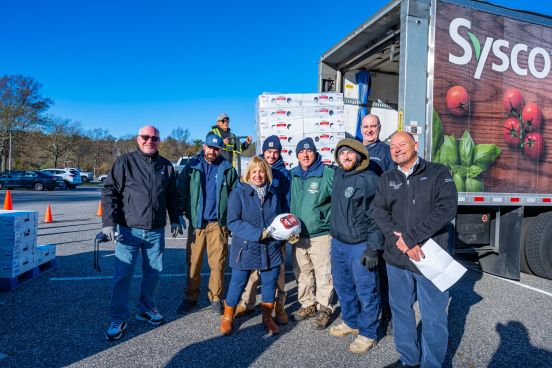 Supervisor Carpenter and Town Personnel in front of loading truck with turkeys and boxes