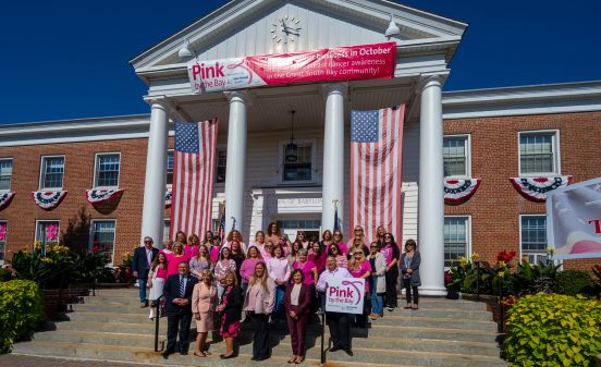 Town Supervisor Angie Carpenter, Town of Babylon Officials, Northwell Health representatives and employees in pink stand outside Town Hall for a group photo.