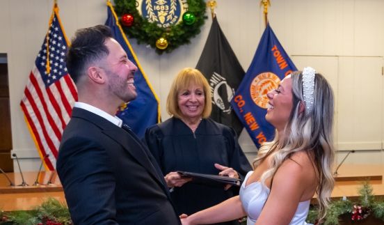 Couple smiles as Supervisor officiates wedding