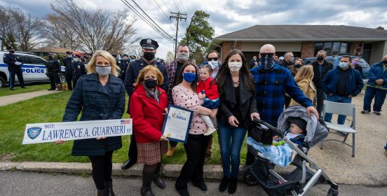 Town Officials and Family take photo with new street sign