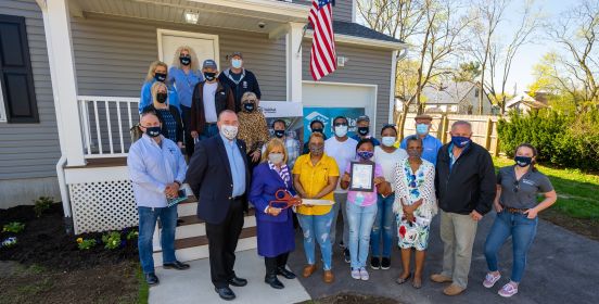 Supervisor Carpenter, Members of Islip Town Board, Representatives from Habitat for Humanity and Family take group photo outside new home.