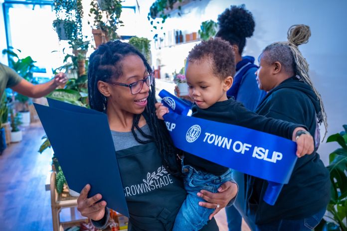 Mother owners shows son Town certificate of recognition
