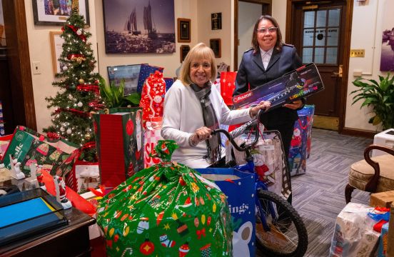 Supervisor Carpenter with gifts alongside Salvation Army Official