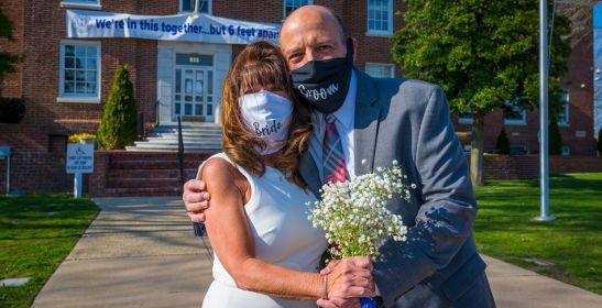 Bride and Groom with masks at their wedding outside of Islip Town Hall