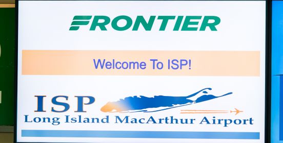 A close up image of the LCD screen behind the Frontier cashier desk reading "Welcome to ISP" with the Frontier and ISP Logos on it.