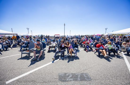 large crowd siting in lawn chairs at the event