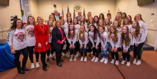 Members of Bayport Volleyball team pose for a photo next to Supervisor Angie Carpenter, Councilwoman Mullen and the Islip Town Board