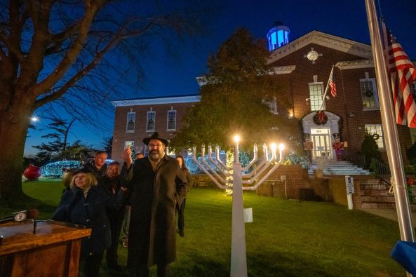 Town Officials gather around the Town Menorah