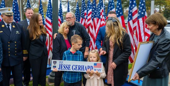Supervisor Carpenter and the Gerhard family stand infront of the Street Sign dedicating S. Bay Ave in Islip to FDNY FF Jesse Gerhard