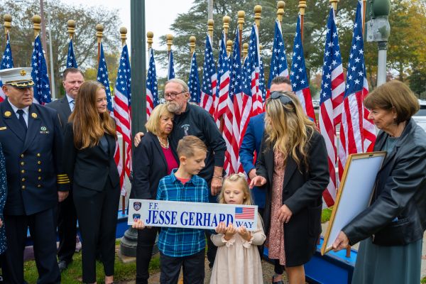 Supervisor Carpenter and the Gerhard family stand infront of the Street Sign dedicating S. Bay Ave in Islip to FDNY FF Jesse Gerhard