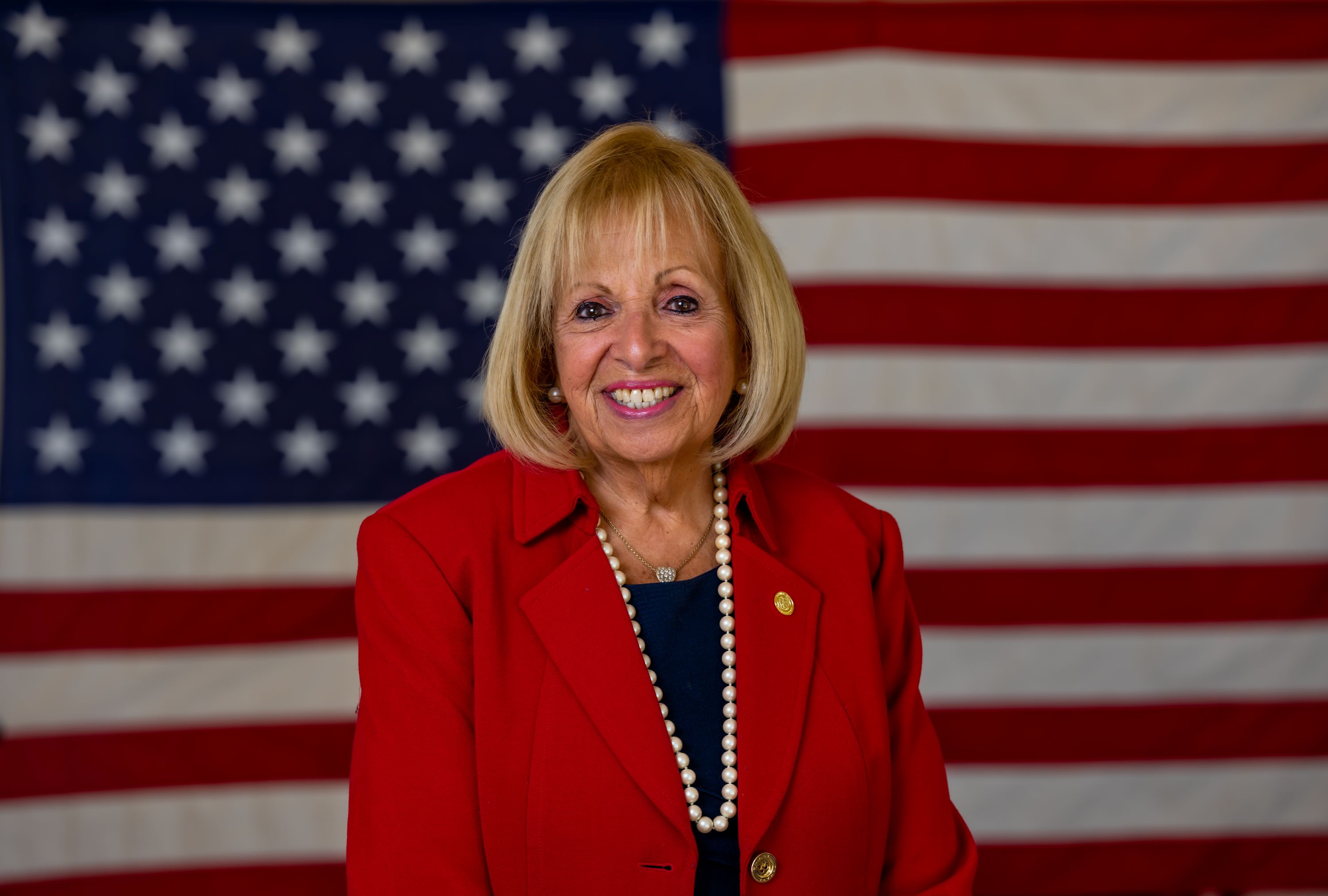 Headshot of Supervisor Carpenter in front of USA flag.