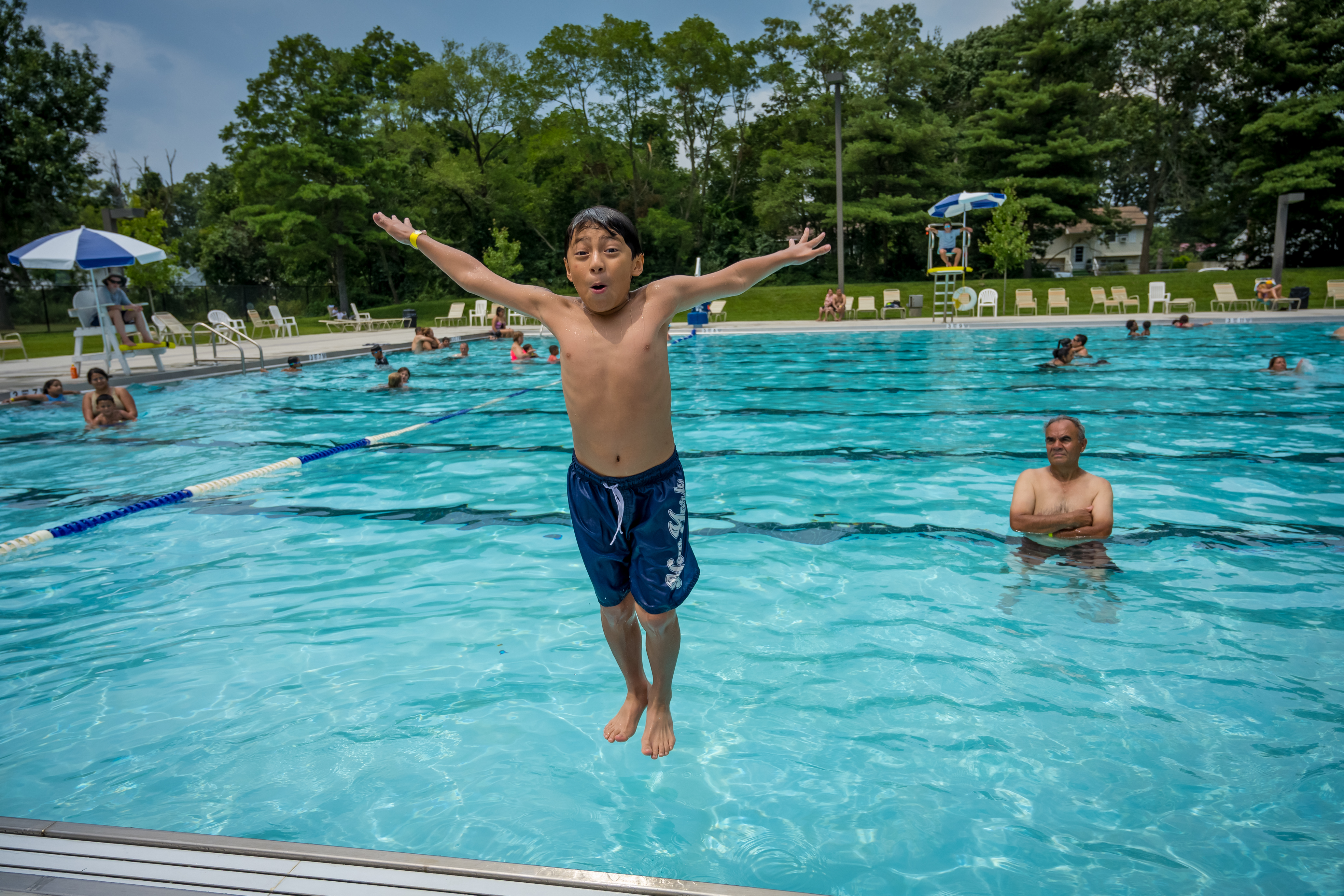 Cool young kid T-Poses backwards into the new waters of Roberto Clemente Pool!